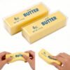 Slow-rise squishy toy shaped like a realistic butter stick, made by NeeDoh