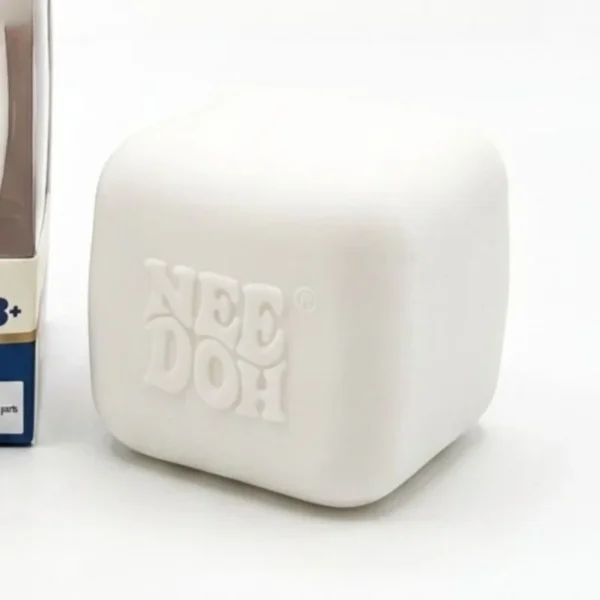 Luminous milk coffee cube Needoh squishy fidget on a desk — Image 5 of 7