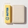 Slow-rise squishy toy shaped like a realistic butter stick, made by NeeDoh
